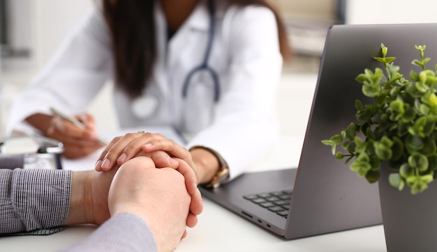 Friendly female doctor hold male patient