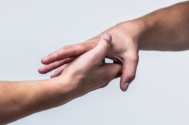 A friendly handshake. Two hands, shaking hands. Two hands, helping arm 