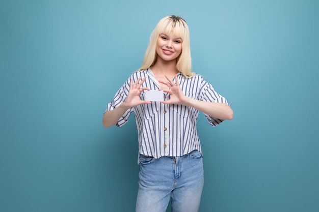 Friendly smiling blonde young female adult in blouse isolated background