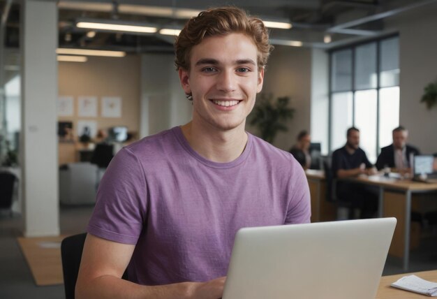 Friendly student working on laptop in office casual and productive