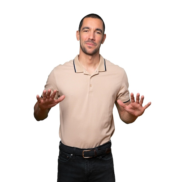 Friendly young man doing a gesture of keep calm