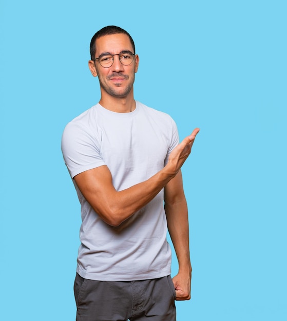 Friendly young man making a gesture of welcome