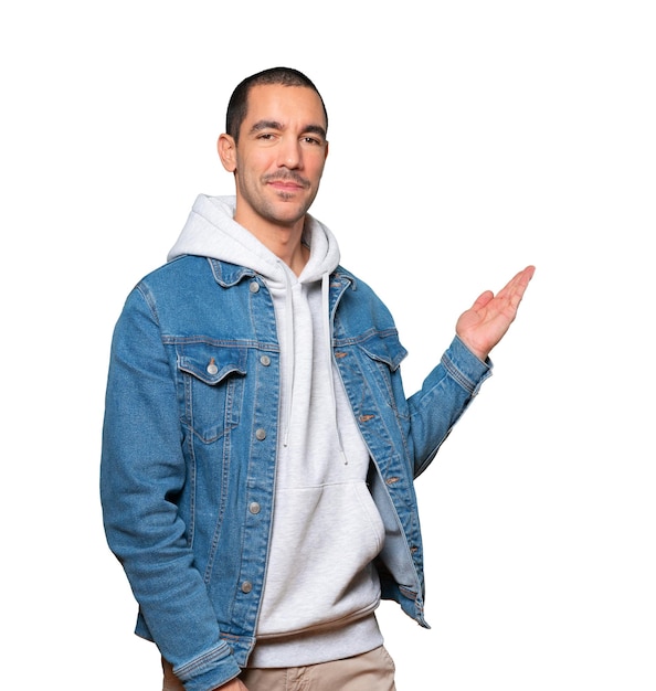 Friendly young man making a gesture of welcome