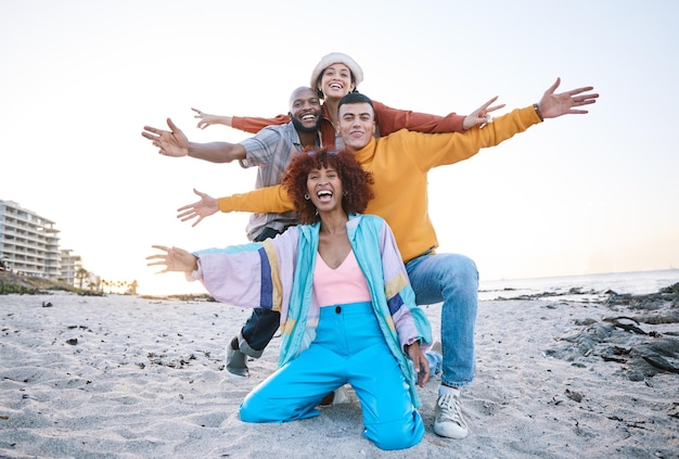 Friends beach and portrait of people outdoor for travel motivation and fun on sand Diversity happiness and gen z group of men and women for adventure arms stretched and freedom in nature