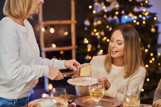 Friends celebrating christmas party holding wine. High quality photo