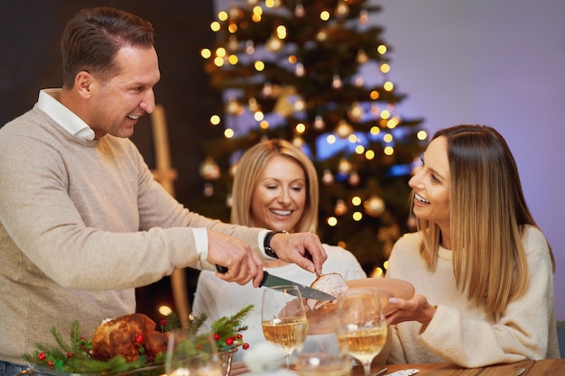 Friends celebrating christmas party holding wine. High quality photo