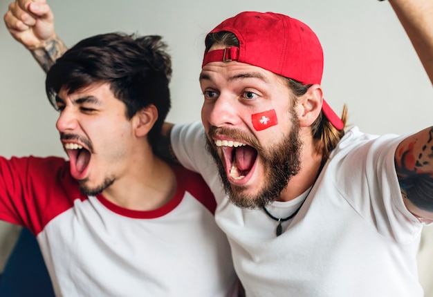 Friends cheering world cup with painted flag