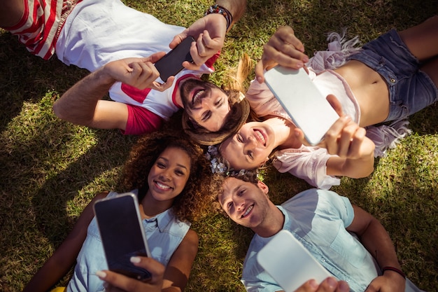 Friends clicking selfie on mobile phones