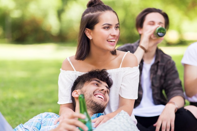 friends drinking non alcoholic beer at summer park