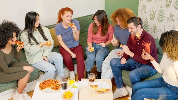 Friends eating pizza and talking at home