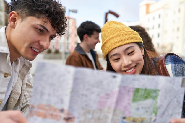 Friends on electric skates check a map before starting their city adventure