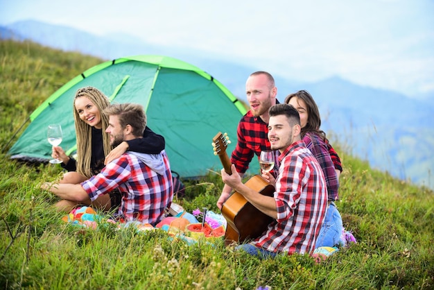 Friends enjoy vacation Pleasant hike picnic People eating food Hike picnic Camping concept Youth having fun picnic in highlands Summer adventures Group friends relaxing picnic in mountains