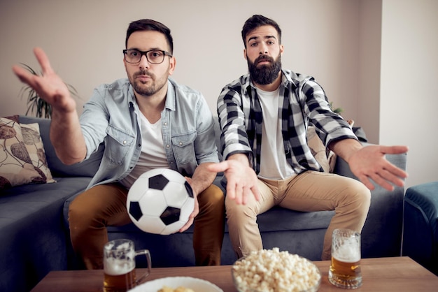 Friends enjoying soccer in TV