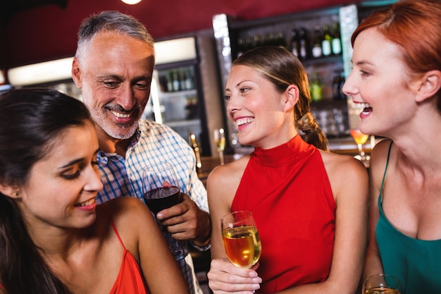 Friends enjoying wine in night club