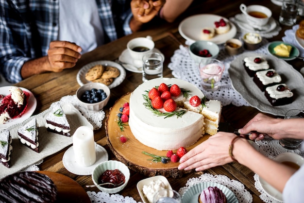 Friends Gathering Together on Tea Party Eating Cakes Enjoyment happiness