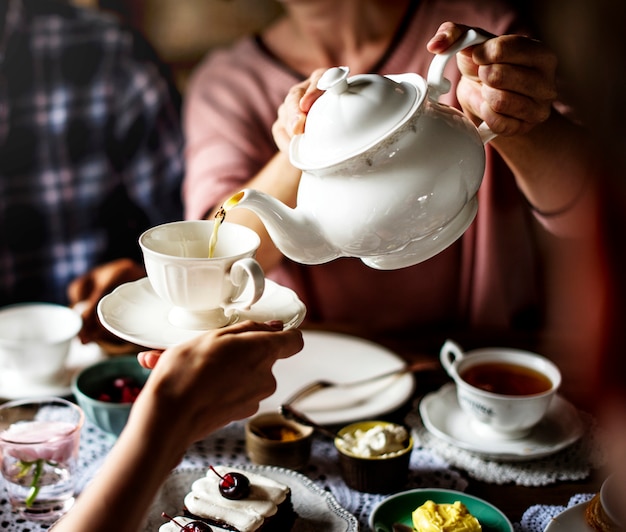 Friends Gathering Together on Tea Party Eating Cakes Enjoyment happiness