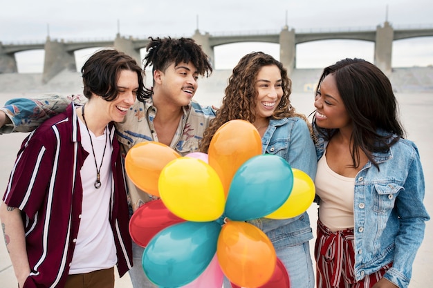 Friends having fun with balloons while out in the city