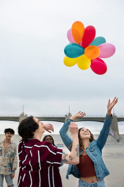 Friends having fun with balloons while out in the city