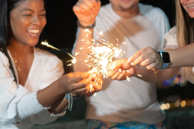 Friends Having Fun With Sparkler At A Party