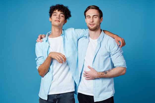 Friends hugging on a blue background fun matching shirts white tshirt pants