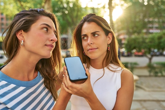 Friends listening to audio message in park