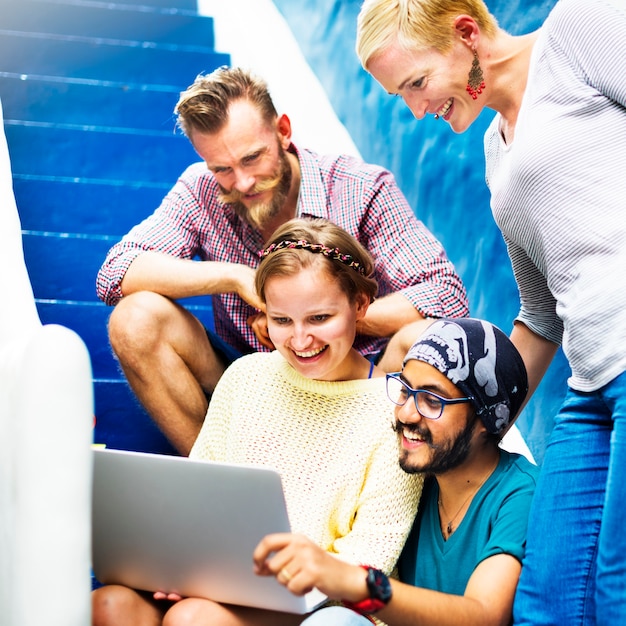 Friends looking at computer laptop together 