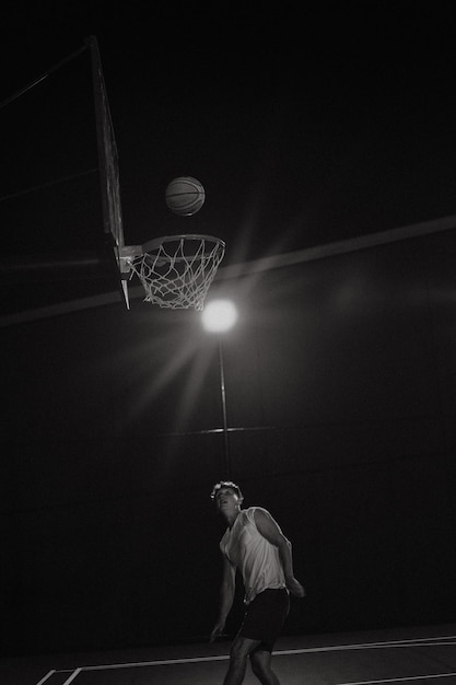 Photo friends play basketball. young men play basketball in the street.