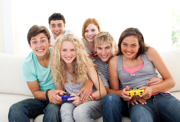 Friends playing video games in the living-room