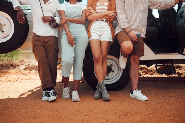 Friends road trip and travel outdoor break of people using motor transportation Diversity of friend group standing on a dirt trail at a vehicle in the summer sun together ready for a holiday