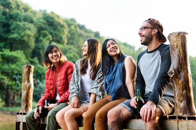 Friends Sitting in a Row Outdoors Concept