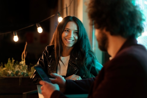 Friends sitting at a table and talking during a night out