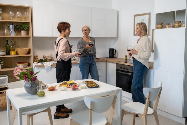 Friends talking during meeting in the kitchen