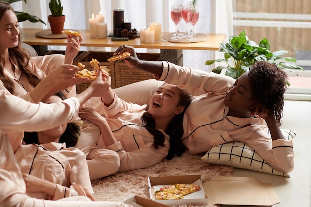 Friends Toasting with Pizza Slices