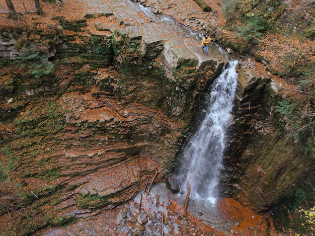 Friends at the top of the waterfall autumn season