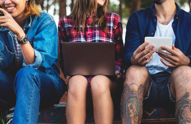 Friends Using Digital Device Outdoors Concept