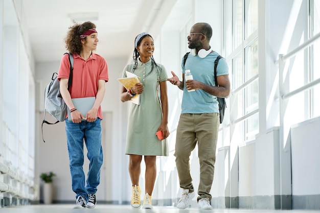 Friends walking along corridor after lessons