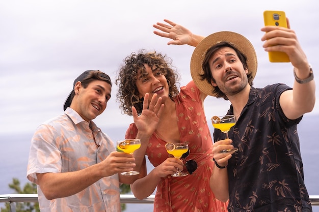 Friends waving at camera in a life video during a party