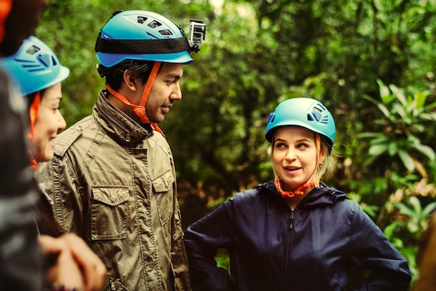 Friends with backpacks trekking through a forest