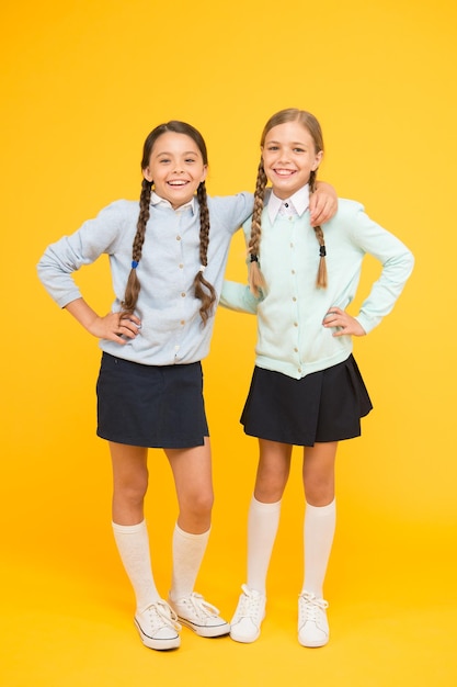 Friendship begins with smile. Happy schoolgirls enjoying bonds of friendship. Little children celebrating friendship day. The glue that holds school friendship together is school.