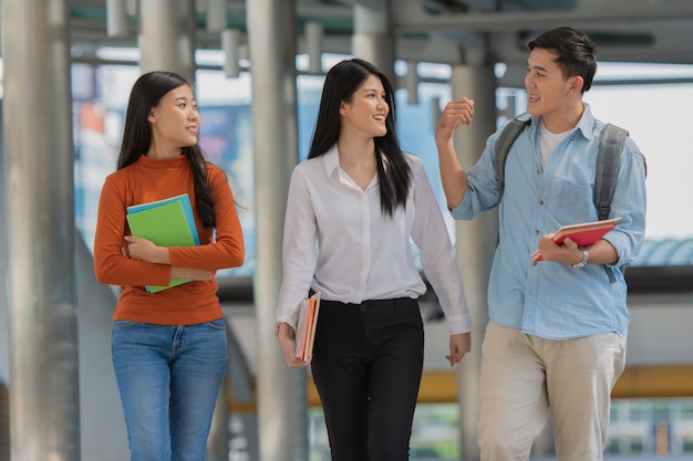 Friendship in campus, College students with books spend time together