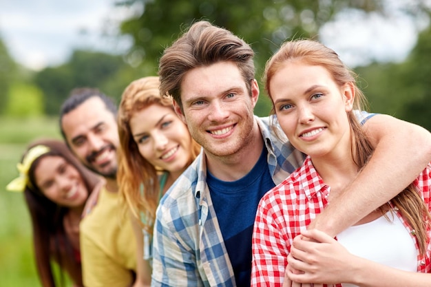 friendship, leisure, summer and people concept - group of smiling friends outdoors