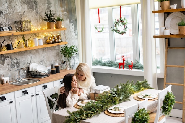 Friendship and love of mom and daughter. Family values. Preparing to celebrate Christmas. Christmas tree decoration. Building a good relationship between mother and daughter.