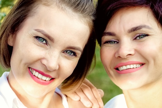 Friendship of women Two beautiful women of Caucasian appearance are smiling Closeup portrait