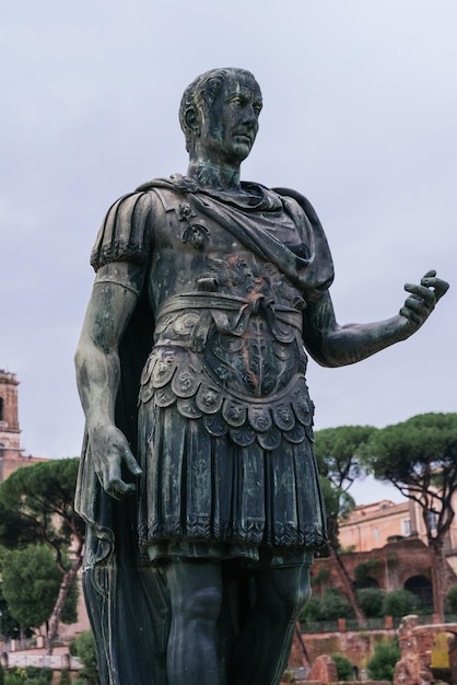 From below of historic stone statue of Julius Caesar located in city center of Rome against cloudy s