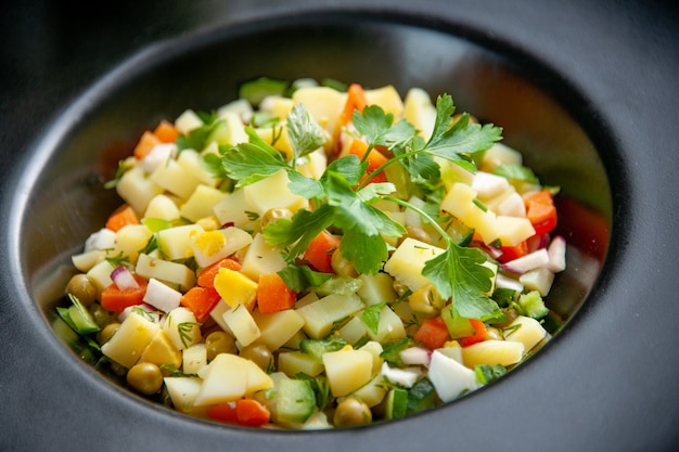 front close view delicious potato salad inside dark plate on dark surface dish health diet food lunch meal bread colour