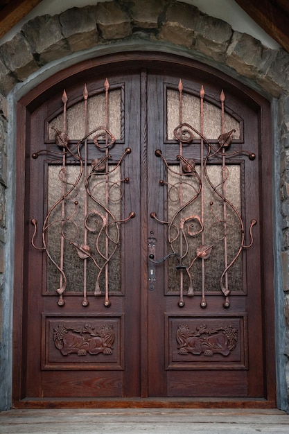 Front door Wooden arched door with decorative elements Decor in construction and architecture