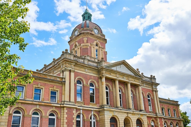 Front of Elkhart County courthouse on blue sky day with fluffy white clouds summer Indiana