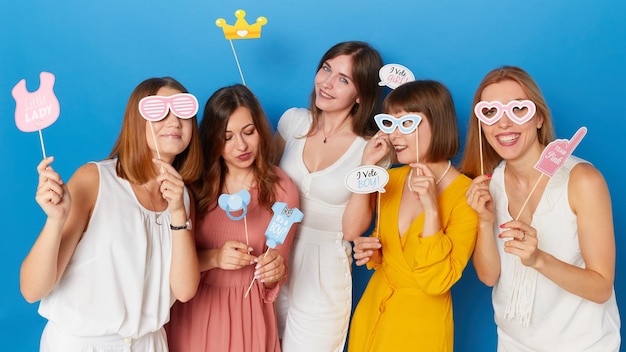 A front image of a group of friends happy to have gender reveals envent isolated blue background