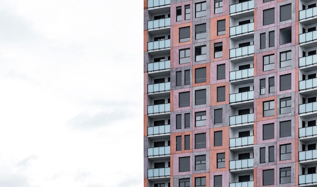 Front view of architectural apartment building in the city with copy space