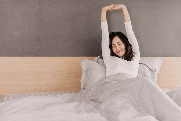 Front view of asian woman in morning. she is stretching hand and body with beautiful smile